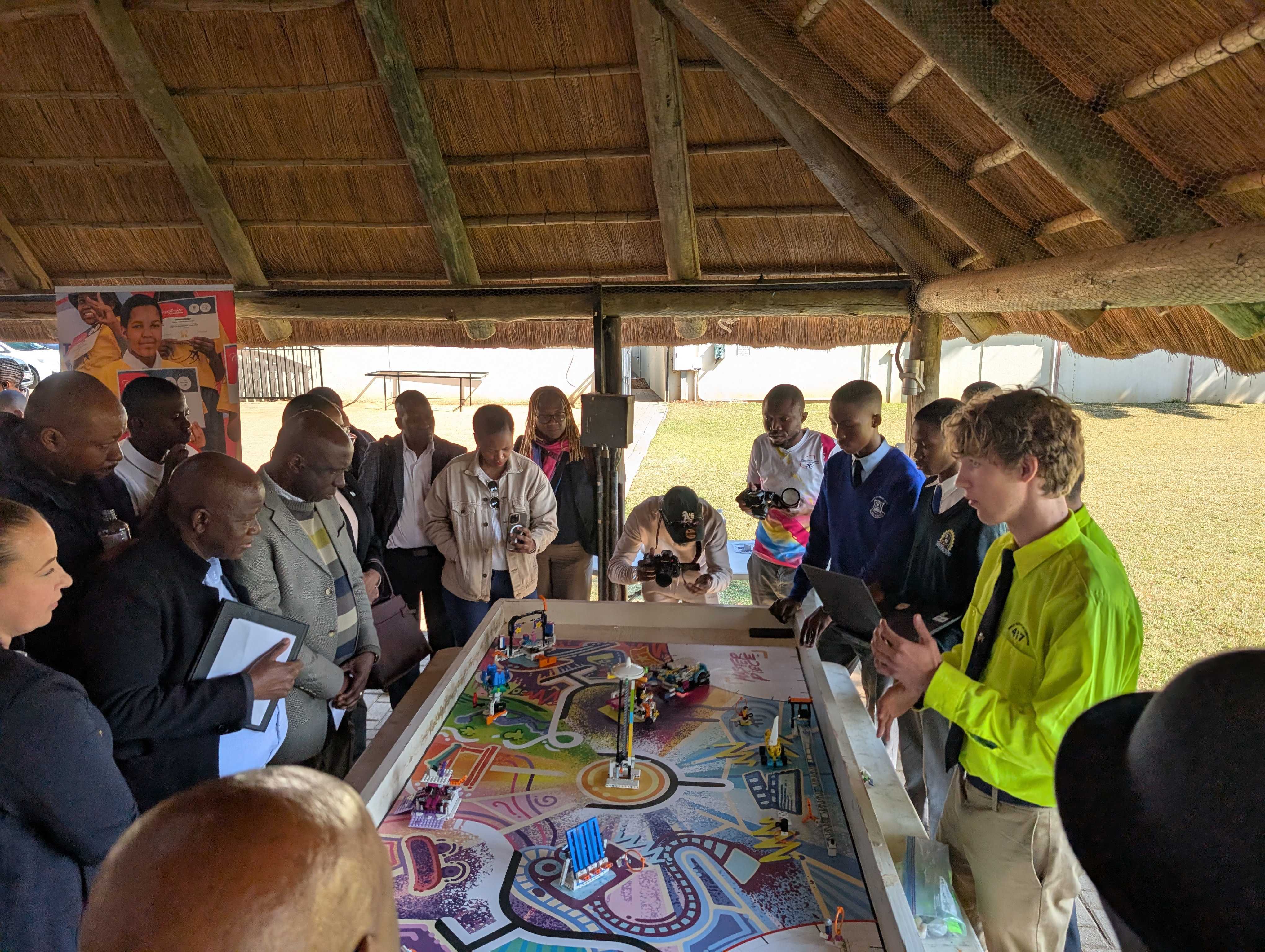 Eric speaking while the Botswana FLL team demonstrates their robot
