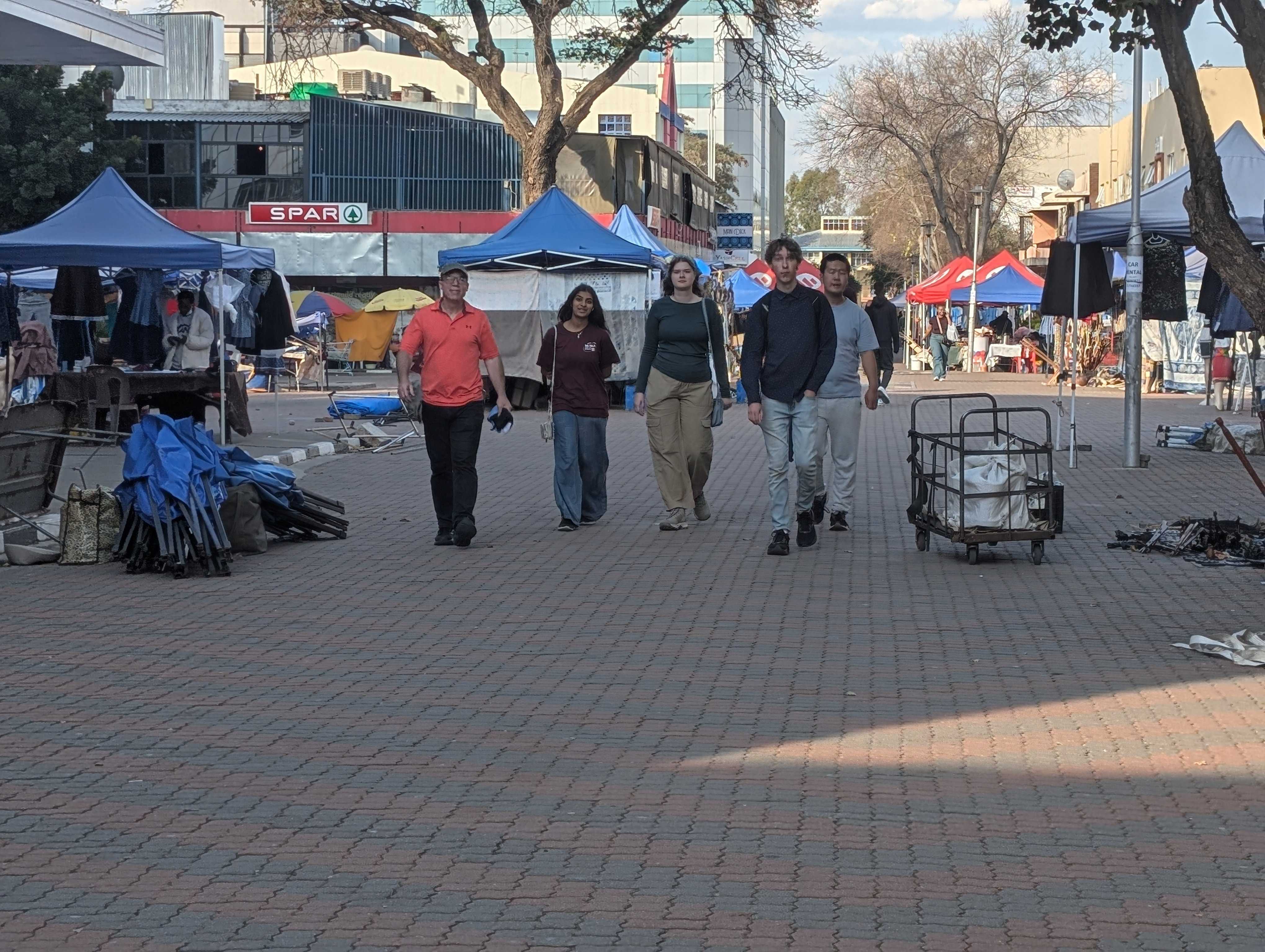 The four of us walking down the stall-lined street